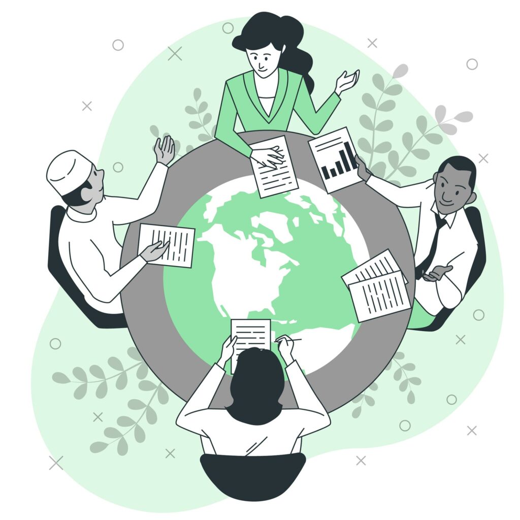 Quatre personnes assises autour d'une table ronde avec en son centre un globe terrestre, ils discutent avec des feuilles de statistique.